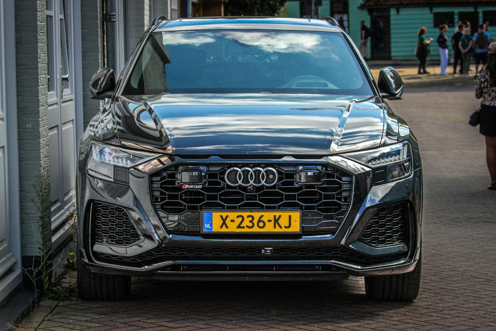 Luxury SUV car parked in a charming Dutch street, showcasing sleek design in a Netherlands setting.